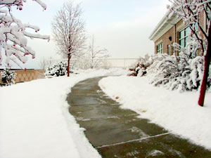 Warmquest heated sidewalk products clearing snow and ice on a building entrance