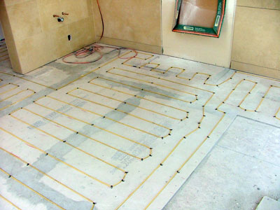 Warmquest's heated floor products heating a tile bathroom